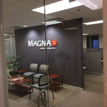 Interior office with acrylic wall sign mounted on a dark gray wall in Chicago Downtown.