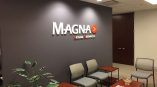 Acrylic wall sign with raised letters and logo mounted on gray wall in Chicago Downtown office.