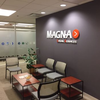 Acrylic wall sign with raised letters and logo mounted on a gray wall in Chicago Downtown.