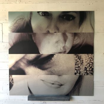 Large artistic metal panel wall sign featuring close-up black and white portraits in Chicago