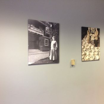 Two black and white canvas prints featuring vintage photos mounted on a gray wall in Chicago