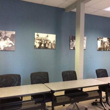 Black and white canvas wall prints mounted above office chairs and tables in Chicago Downtown.