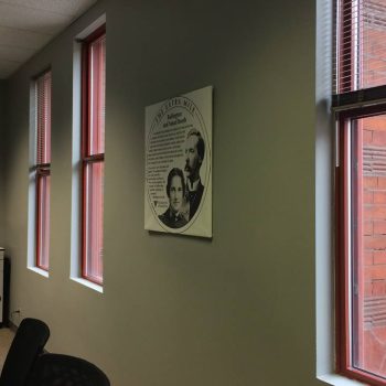 Canvas wall sign with black and white portrait print in office room in Chicago Downtown.