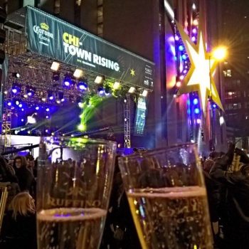 Large event banner and illuminated star wall sign at nighttime in Chicago Downtown.