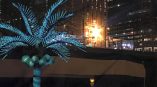 Illuminated LED palm tree decoration and large star light sign in Chicago Downtown at night.