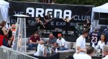Large black vinyl event banner with white text behind live band setup in Chicago Downtown.