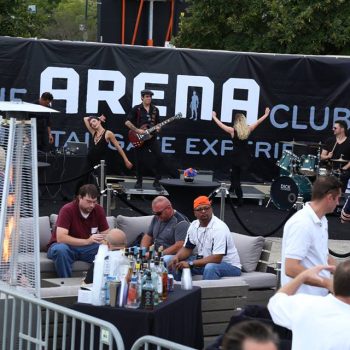 Large black vinyl event banner with white text behind live band setup in Chicago Downtown.