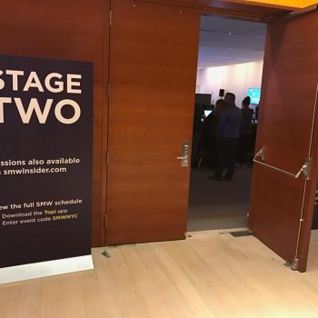 Freestanding fabric banner signage with metal base at event entrance in Chicago Downtown.