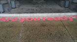 Pink vinyl floor graphic applied on concrete step at building entrance in Chicago Downtown.