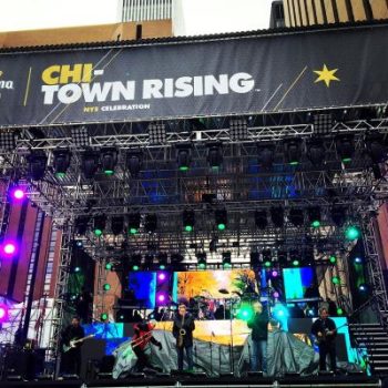 Large fabric event banner mounted on metal truss stage structure in Chicago Downtown.