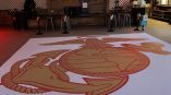 Large floor graphic of an anchor and eagle emblem on a white vinyl floor decal in Chicago Downtown.