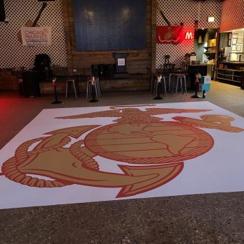 Large floor graphic of an anchor and eagle emblem on a white vinyl floor decal in Chicago Downtown.