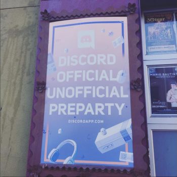 Event poster mounted on a decorative purple frame displayed on a building wall in Chicago Downtown.