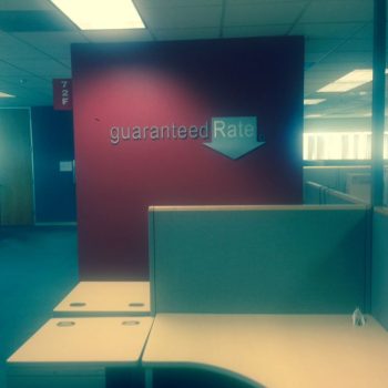 Dimensional office wall letters mounted on a maroon wall in Chicago Downtown office.