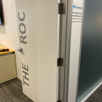 Interior office door with vinyl lettering and a printed wall sign in Chicago Downtown.