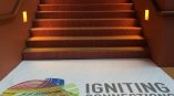 Floor graphic with colorful abstract design and text on landing of indoor stairs in Chicago