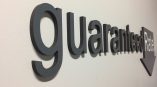 Dimensional foam office wall letters spelling guaranteed rate with arrow in Chicago Downtown.
