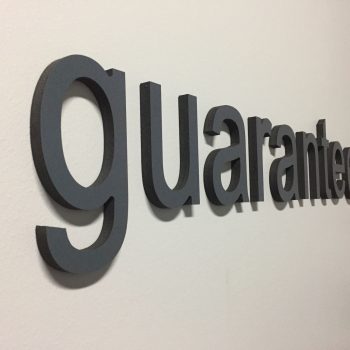 Dimensional foam office wall letters spelling guaranteed rate with arrow in Chicago Downtown.