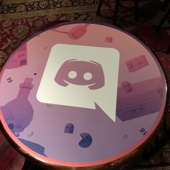 Round vinyl table wrap with digital graphic print on wooden table in Chicago Downtown.