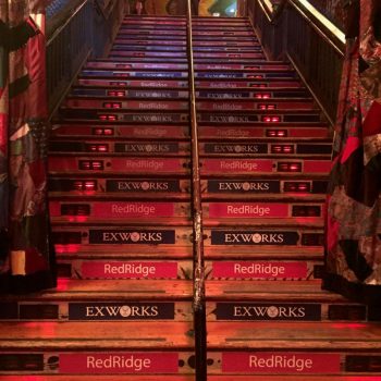 Wooden staircase with red and blue floor stair graphics in Chicago Downtown.