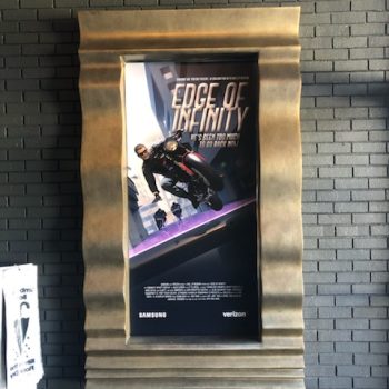 Framed poster display mounted on textured brick wall in Chicago Downtown.