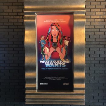 Framed poster mounted on black brick wall with decorative metal frame in Chicago Downtown.