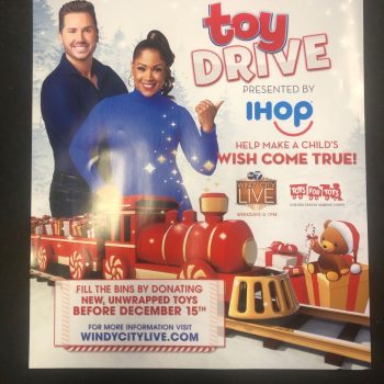 Holiday toy drive promotional poster with people and toy train printed on paper in Chicago Downtown.