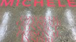 Red vinyl floor graphics with text applied on polished concrete in Chicago Downtown.