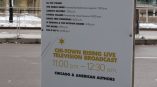 Freestanding event schedule sign printed on rigid board displayed outdoors in Chicago Downtown.