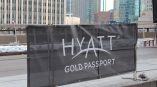 Black mesh banner with grommets mounted on metal barricade in Chicago Downtown.