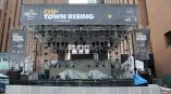 Large vinyl event banners and stage truss setup with lighting in Chicago Downtown.