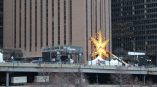 Large yellow star-shaped event sign mounted on building wall with tents in Chicago Downtown.