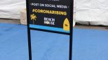 Freestanding metal frame sign with printed event instructions on black board in Chicago Downtown.