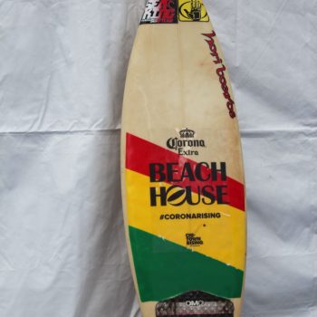 Surfboard with colorful graphic vinyl decals and grip pad displayed in Chicago Downtown.
