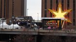 Outdoor event stage with truss banner and large illuminated star wall sign in Chicago Downtown.