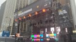 Outdoor event stage with large vinyl banners and LED screens in Chicago Downtown.