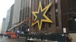 Large yellow star-shaped wall sign mounted on a brick building in Chicago Downtown.