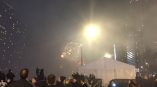 Event tent with metal frame and white fabric walls at night in Chicago Downtown.