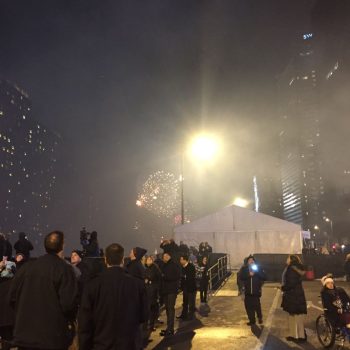 Event tent with metal frame and white fabric walls at night in Chicago Downtown.