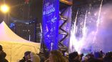 Large vertical event banner on scissor lift with fireworks and crowd in Chicago Downtown.