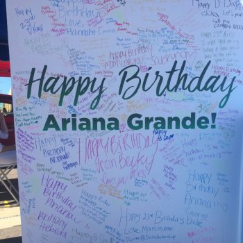 Large white event board with colorful handwritten messages and signatures in Chicago Downtown.