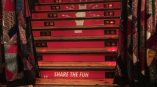 Red vinyl stair graphics with social media icons and symbols on wooden stairs in Chicago Downtown.