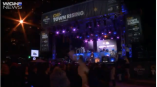 Large outdoor event stage banner and vertical hanging signs with lighting in Chicago Downtown.