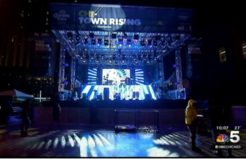 Large event stage with truss lighting and vinyl banner signage in Chicago Downtown.