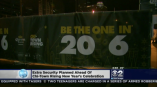Large vinyl event banner with printed graphics attached to metal fencing in Chicago Downtown.
