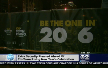 Large vinyl event banner with printed graphics attached to metal fencing in Chicago Downtown.