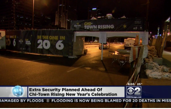 Outdoor fabric event banners mounted on metal barricades at night in Chicago Downtown.