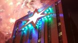 Large building banner with star graphic and fireworks in Chicago Downtown skyline.
