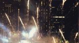 Illuminated star-shaped rooftop sign with fireworks display in Chicago Downtown at night.
