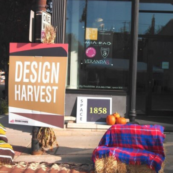 Poster for Design Harvest next to hay stacks